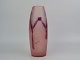 a pink vase with a bird on it on a white surface