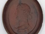 a picture of a brown plate with a picture of a woman on it