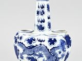a blue and white vase with a dragon on it