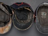 three pairs of old baseball caps sitting on top of a table