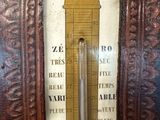 an old fashioned thermometer on display in a frame