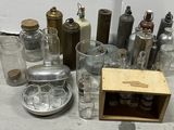 a lot of glass bottles and a wooden box on the floor