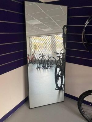 a bike that is sitting in front of a mirror in a room