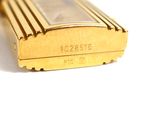 a close up of a gold cell phone on a white surface