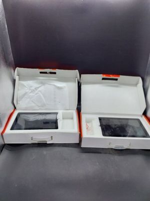 two open boxes of electronic devices sitting on a table