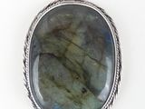 a close up of a pendant with a stone on a chain