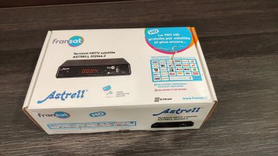 a box that is sitting on a table with a remote in it