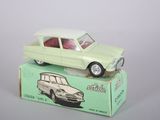 a green toy car sitting on top of a box