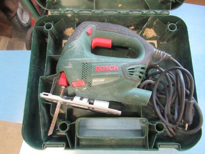 a green box with tools in it sitting on a table