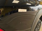 a sticker on the back of a car that is parked in a garage
