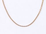 a close up of a gold chain necklace on a white background