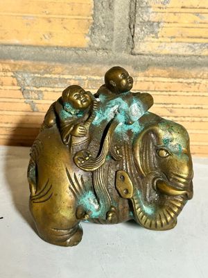 a statue of an elephant with a man riding on it