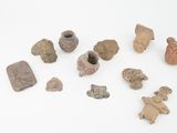 several pieces of pottery sitting on top of a white surface