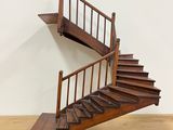 a wooden staircase that is on a wooden table