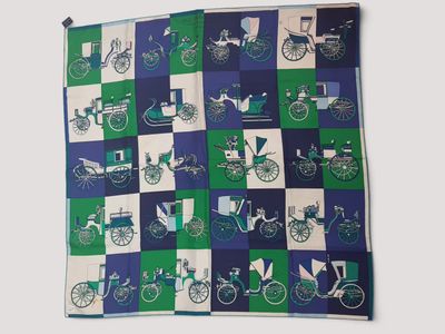 une image représentant une couette bleue et verte ornée d'un motif représentant un cheval et une calèche