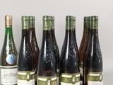 six bottles of wine are lined up on a table