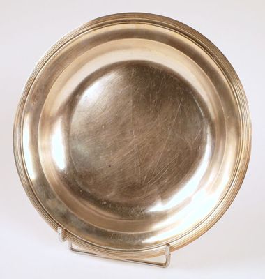 silver plate on stand on white surface with white background