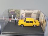 a display case with a yellow taxi and a man
