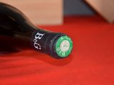 a bottle of red wine on a red cloth