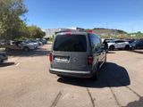 the van is parked in the parking lot near many cars