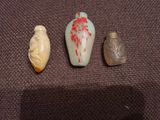 trois petits vases posés l'un à côté de l'autre sur une table