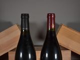 two bottles of wine sitting next to each other on a table