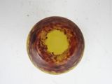 a brown bowl with a yellow center on a table
