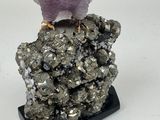 crystal owl sitting on a rock with a purple crystal on it ' s head
