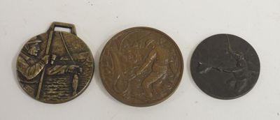 three bronze medals with a picture of a man and a woman