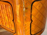 a wooden cabinet with a mirror on top of it