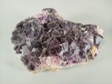 purple crystals on a white surface with a white background