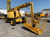 a yellow crane that is sitting in a parking lot