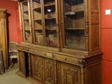 a large wooden china cabinet in the middle of a room