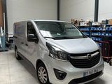 the silver van is parked in the garage of a warehouse