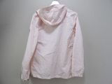 pink jacket hanging on a hanger against a white wall