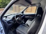 the interior of a car with the door open and the driver ' s seat up