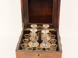 an old wooden box with a set of glasses in it