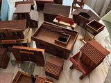 a table that has a bunch of wooden furniture on it