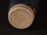 a close up of a vase on a black surface