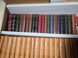 a lot of books that are on a shelf
