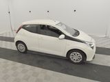 a picture of a small white car parked in a garage