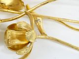 a close up of a gold plate with a flower on it