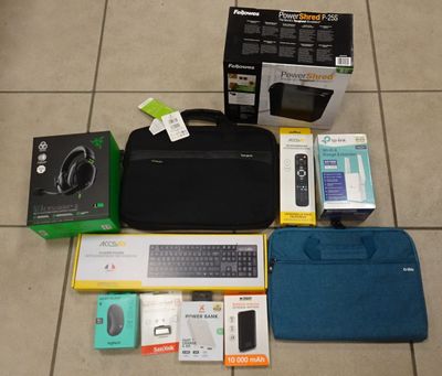 a laptop and other electronics on the floor next to a bag