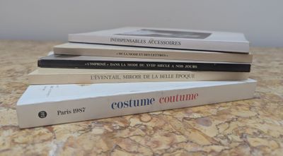 three books are stacked on top of each other on a table