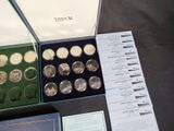 a lot of coins in a box on a table