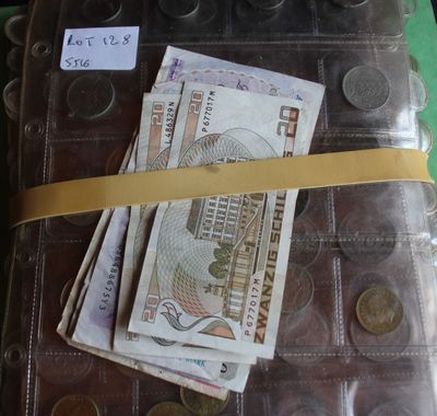 a lot of money sitting on top of a suitcase