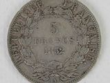 a close up of a coin with a wreath on it