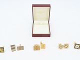 a box with a ring, cufflinks, and a pair of cufflinks