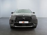 the front view of a grey dsx suv parked in a showroom