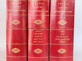 three red books with gold trims are stacked on top of each other